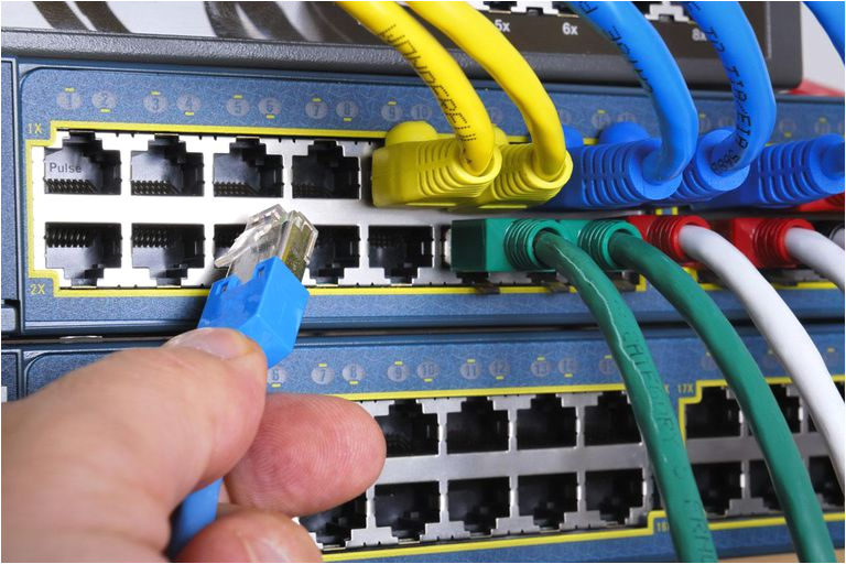 it administrator plugging network cables network switch