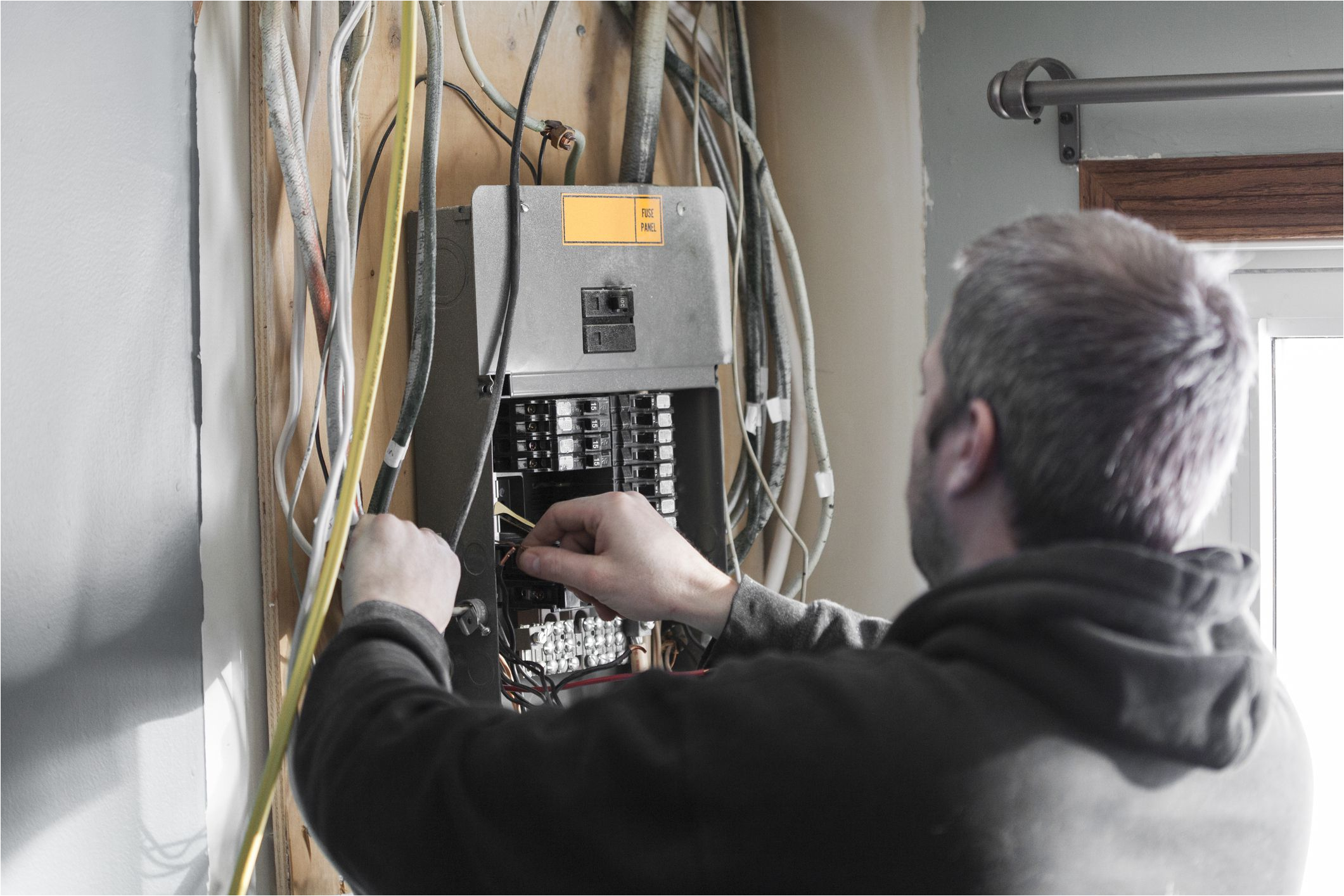 electrician upgrading a homes distribution board 958969076 5c61c76446e0fb0001dcd5d1 jpg